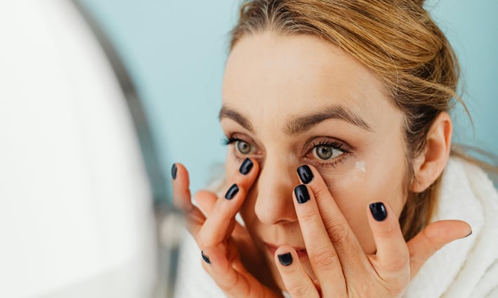 Woman applying face cream in the morning