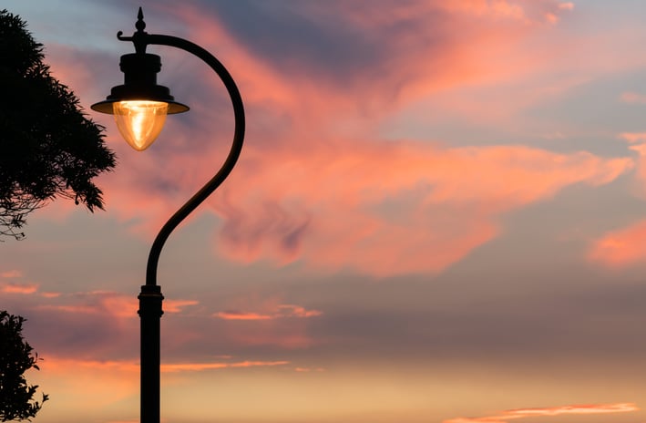 a street light on Lugard Road Hong Kong with a sunset in the background