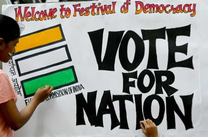 a woman holding a sign that says vote for the nation