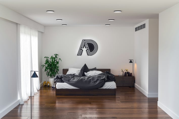 a bedroom with a bed and a lamp