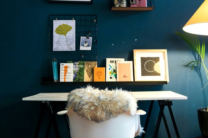 a desk with a chair and a lamp