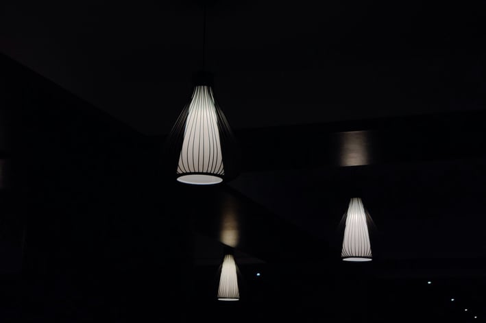 a group of three lamps hanging from a ceiling