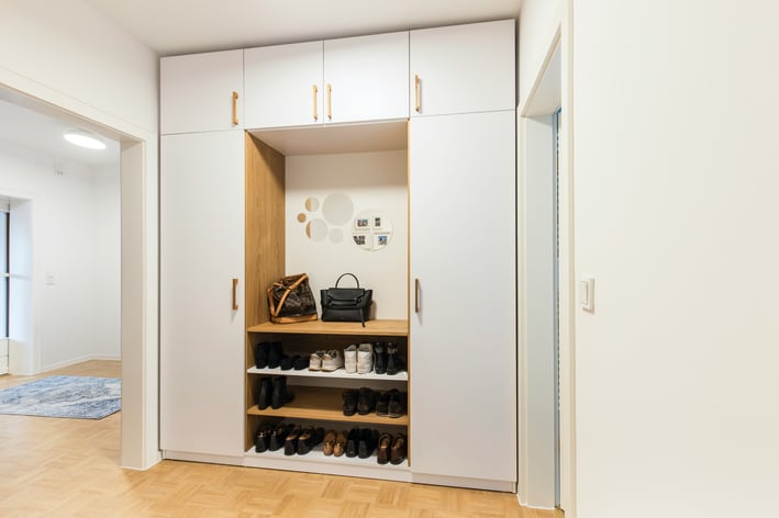a wardrobe with a lot of shoes and a purse