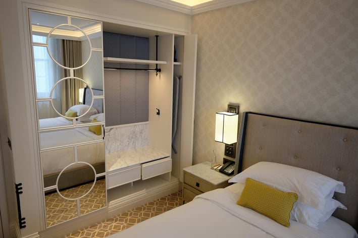 a bedroom with a bed and a mirror