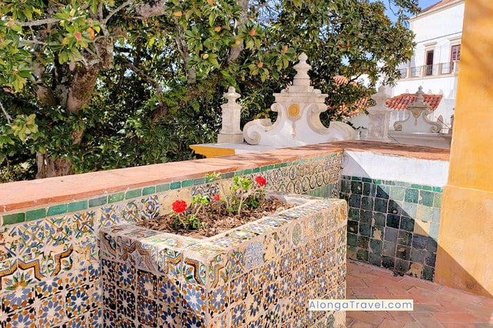 A planter with flowers in a tiled azulejos wall in the Moorish section of National Palácio de Sintra