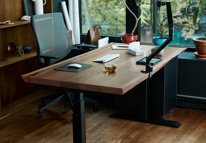 a desk with a laptop and a laptop on a wooden desk