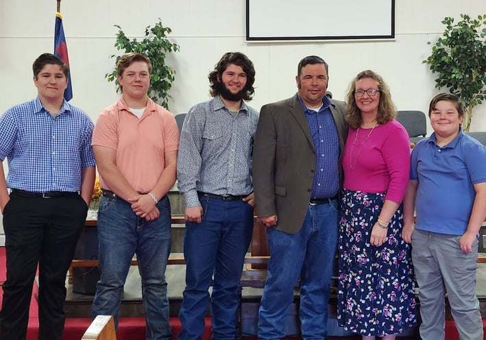 Dawson family standing in the front of the church