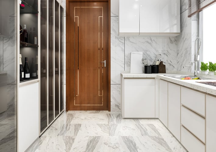 a kitchen with a wooden door and a wooden door