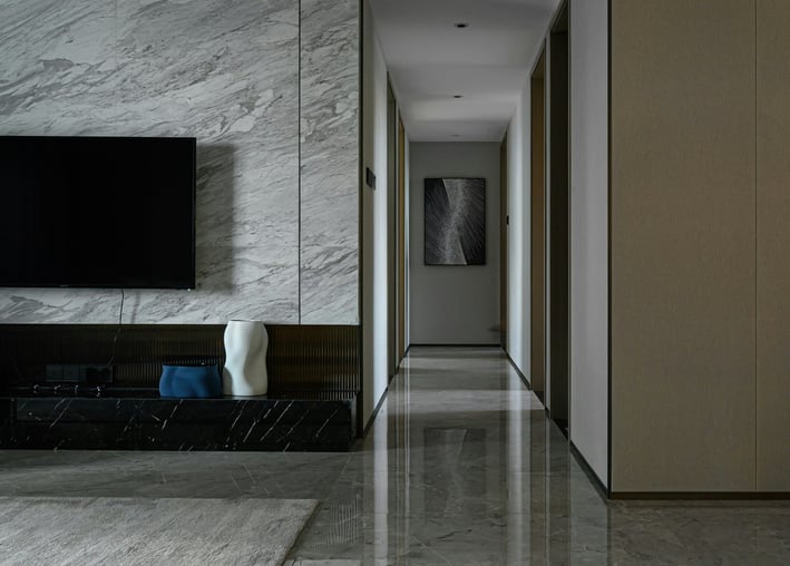 a long hallway with a television and a flat screen tv