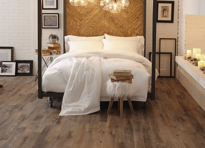 black bed frame with white comforter, dark wood peel and stick vinyl