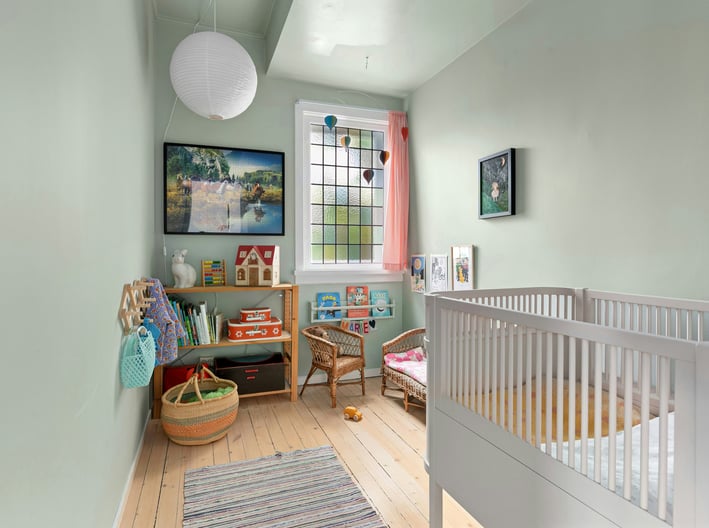 a baby's room with a crib and a crib
