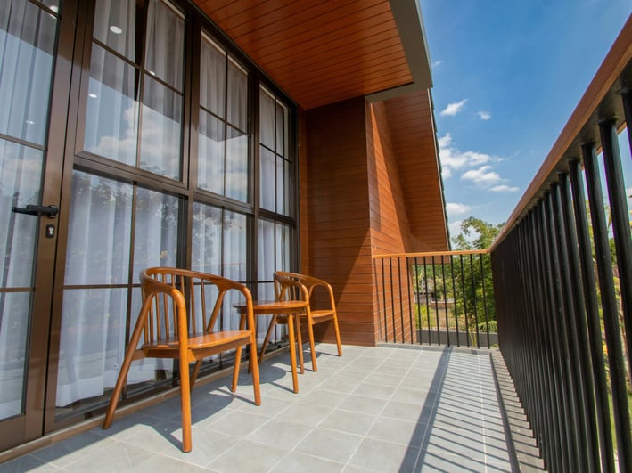 a balcony with chairs and a table with chairs