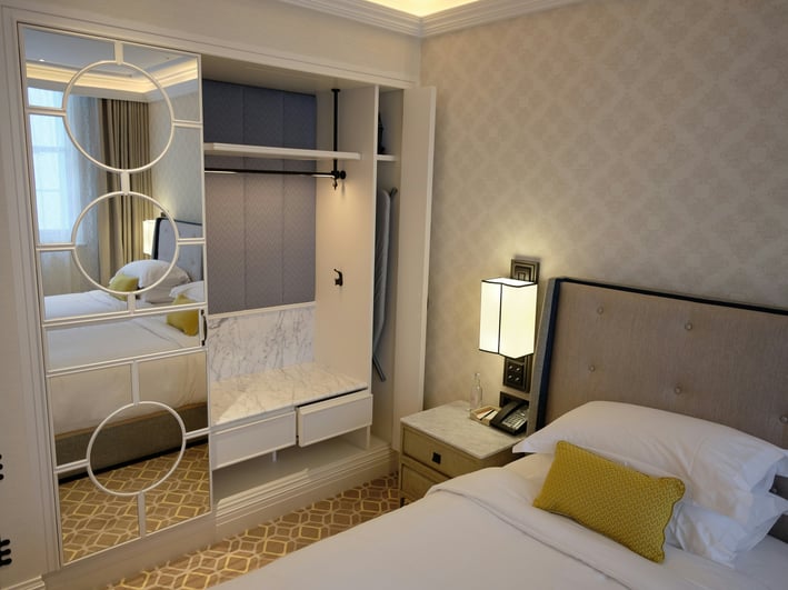 a bedroom with a bed and a mirror
