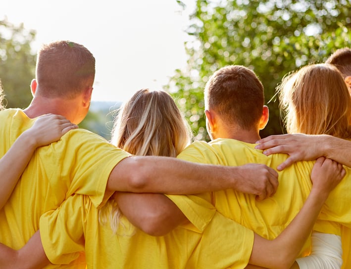 a group of people in yellow shirts and yellow shirts