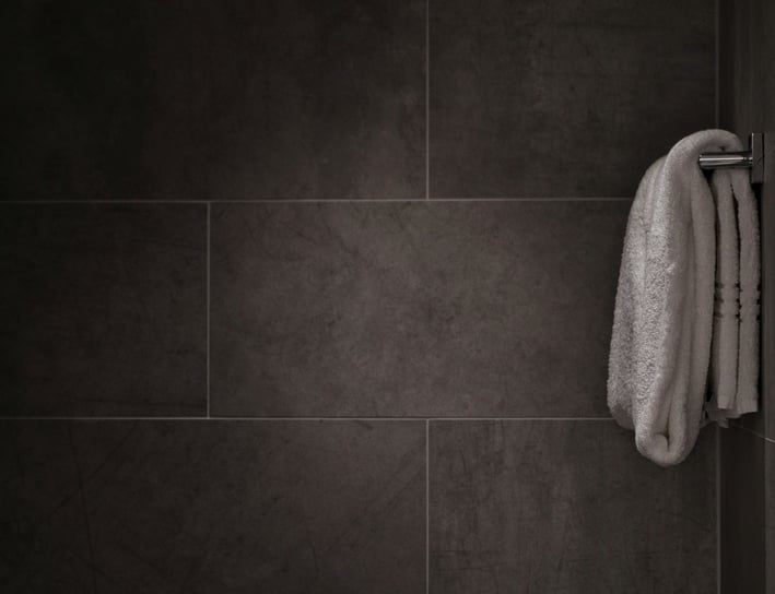 a towel hanging on a wall in a bathroom