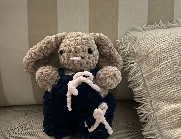 a plush bunny is sitting on a couch