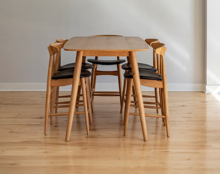 a dining room table with chairs and a chandelier