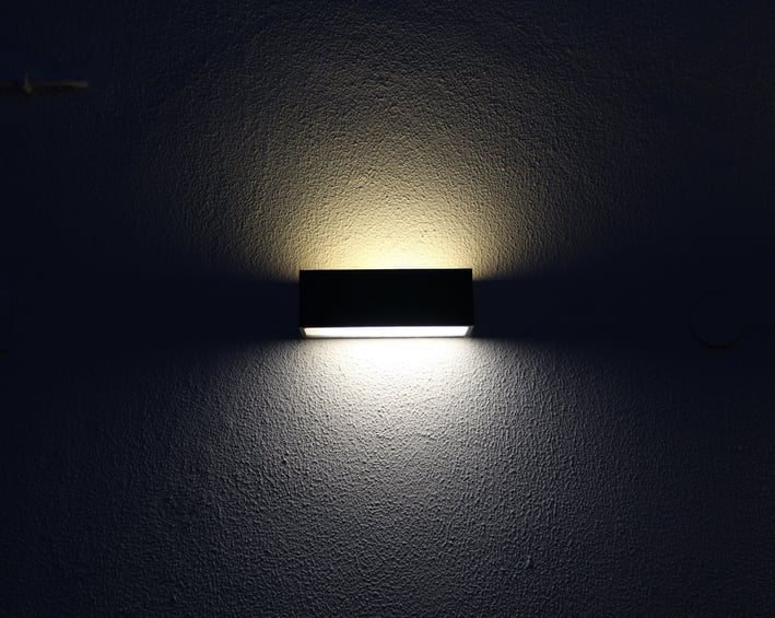 a wall light with a small square light on it
