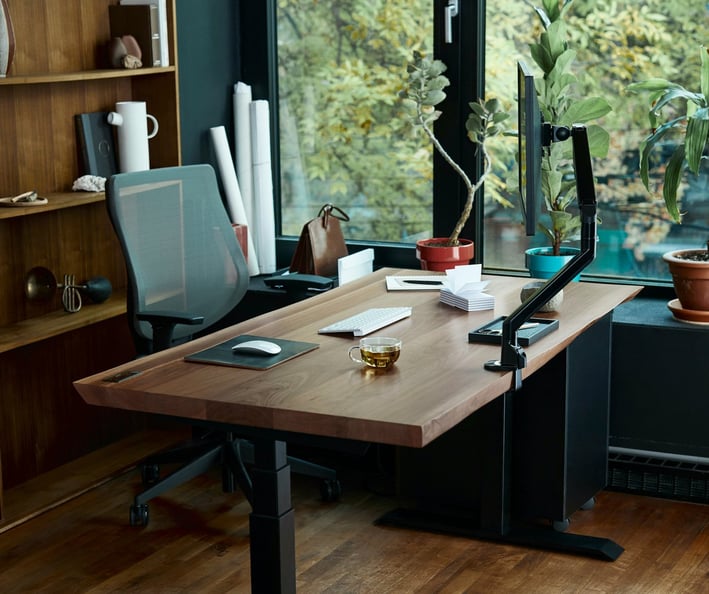 a desk with a laptop and a laptop on a wooden desk