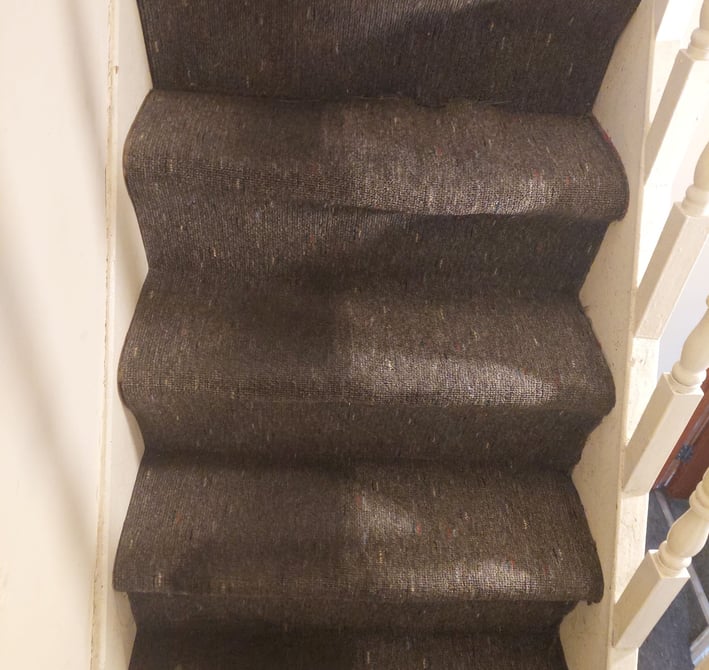heavy soiled staircase with blacktop dirt in the process of being deep cleaned
