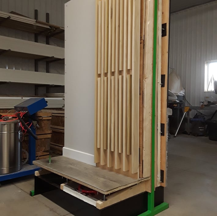 Interior wall mock-up with decorative wood slat paneling and raised flooring system for design and construction display
