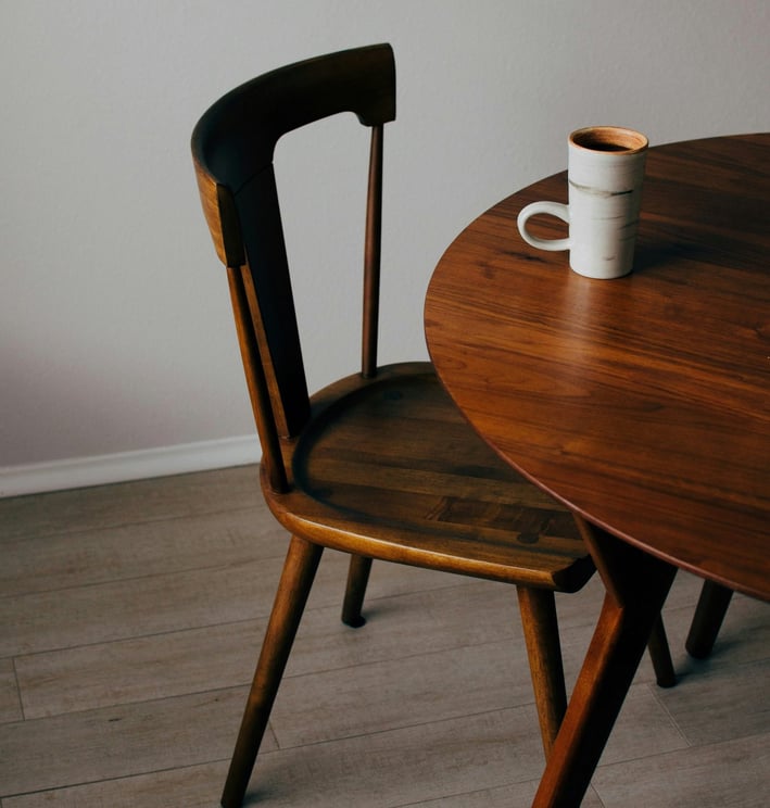 a coffee cup and a mug of coffee on a table