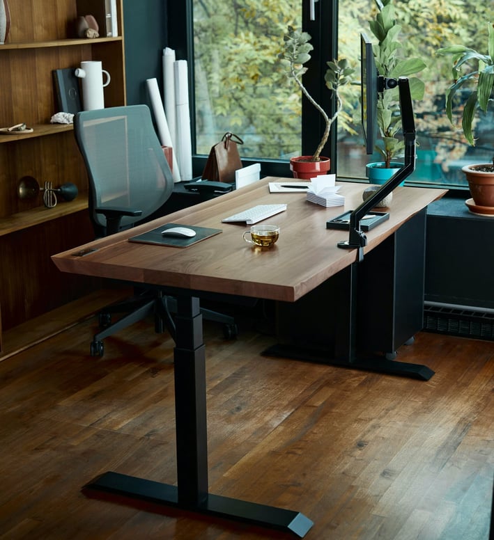 a desk with a laptop and a laptop on a wooden desk