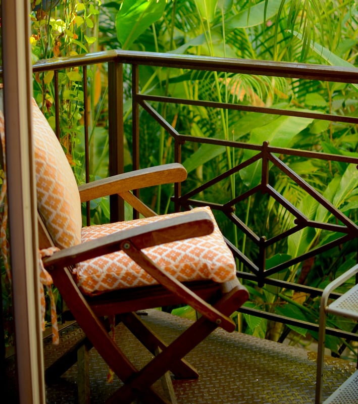 a chair with a chair and a chair in front of a balcony
