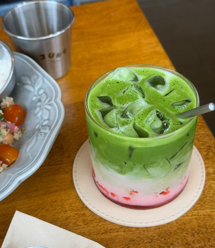 Layered strawberry matcha latte with fresh strawberries