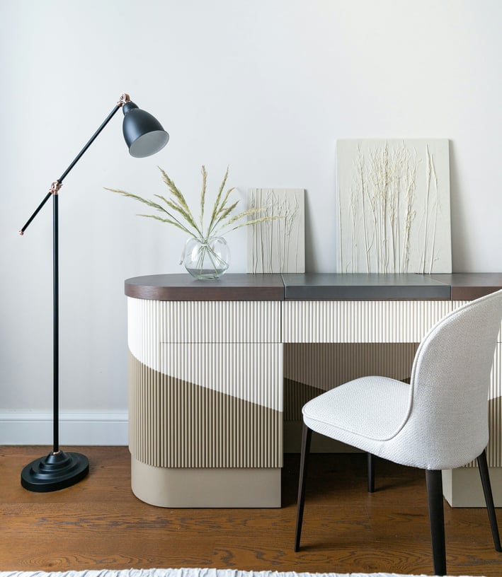 a desk with a lamp and a lamp on a table