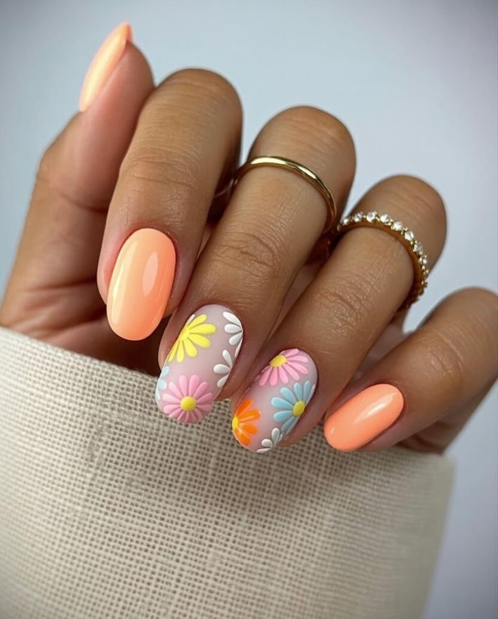 Neon peach nails with 3D pastel daisies