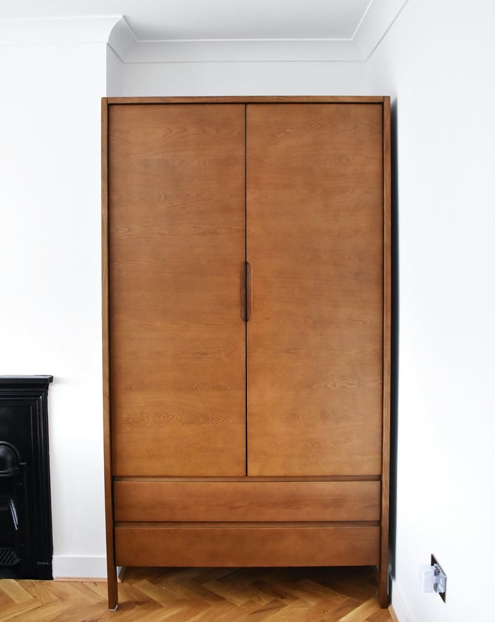 a wooden cabinet with a fireplace in a room