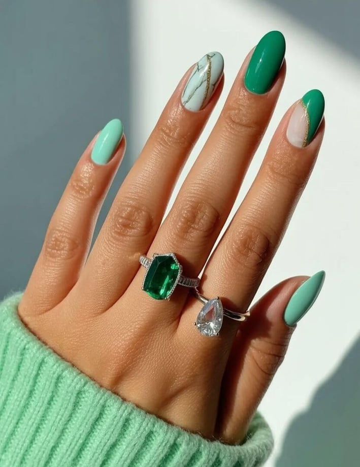Green nails with marble and gold accents