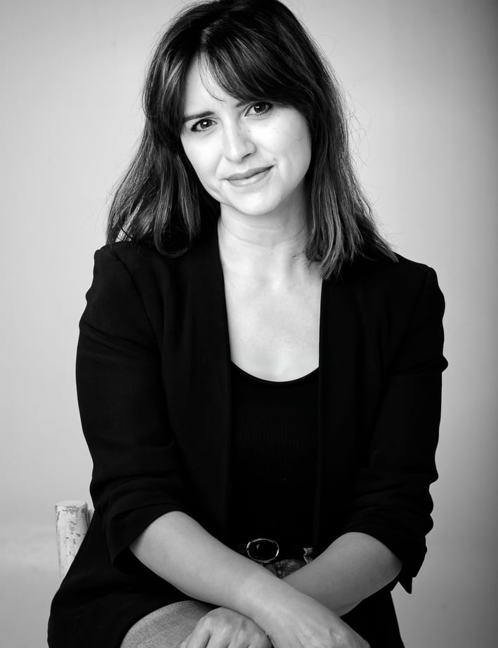 a business woman sitting on a chair with her hands on her knees