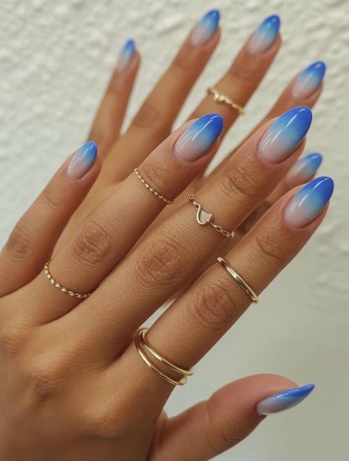 Almond nails with nude to blue ombre gradient