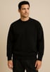 a man in a black sweater and pants