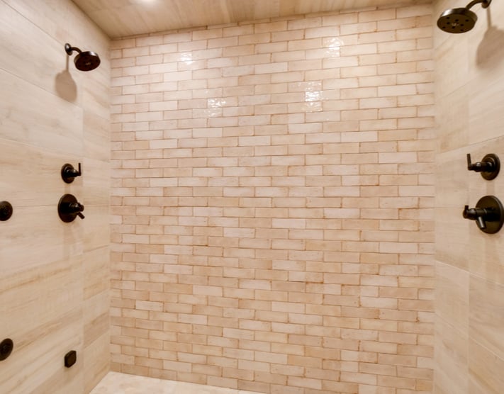 A bathroom with a showers on 2 sides