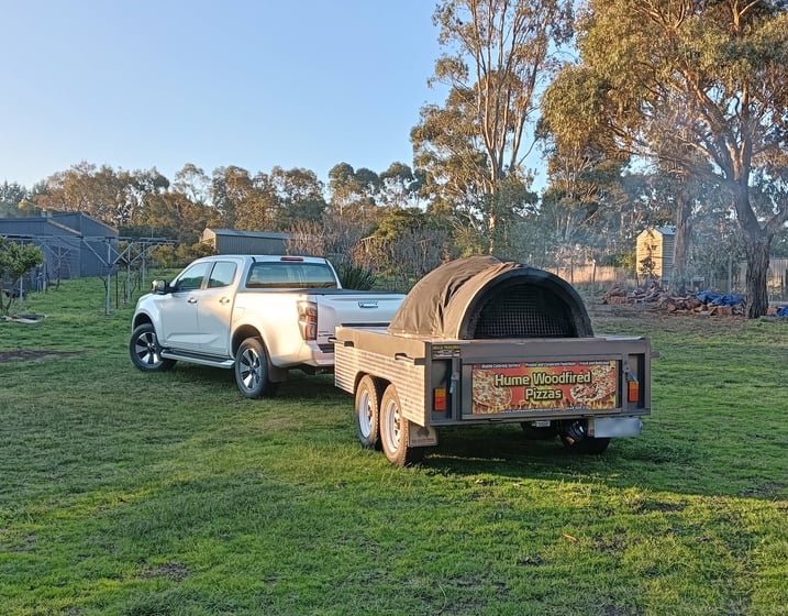car with an oven pizza trailer