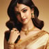 a beautiful young woman in a gold sari