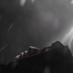 Scene from short film - visual of free falling of figure in black hoodie in hopeless face in lightning dark foggy sky