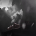 Dark cinematic shot - man in black hoodie's face as he's free falling while thunder lightning in dark