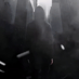 Dark cinematic shot - man in black hoodie under urban midnight fog