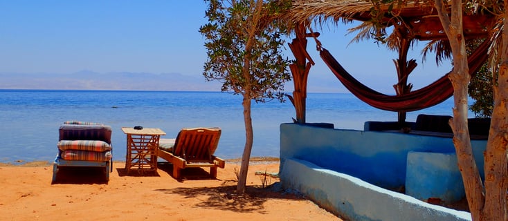 beachview with chaise lounge and bungalow in front of the sea Bedouin star Egypt