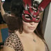 a woman in a leopard print dress and a mask