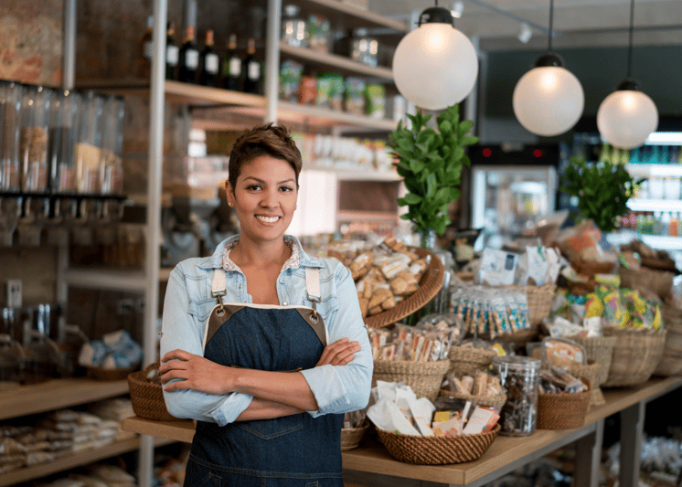 A happy store owner standing in her shop.