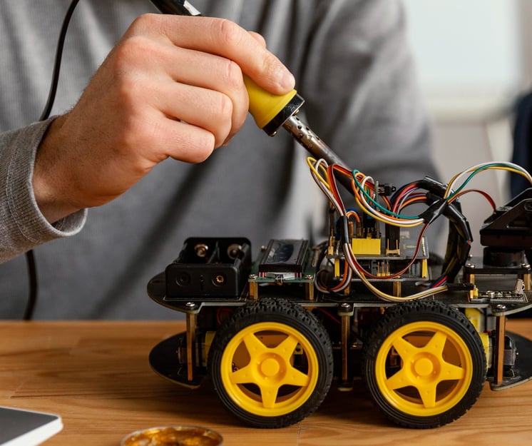 a man and a boy are building a robotic car