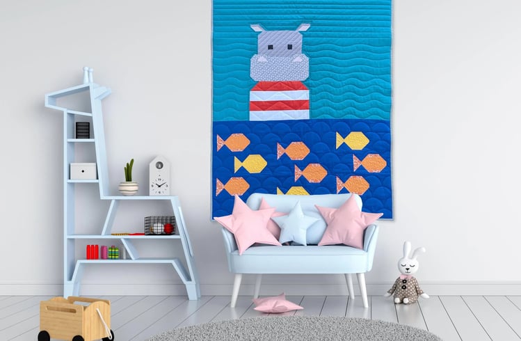 a room with a couch and quilt with a hippo 
