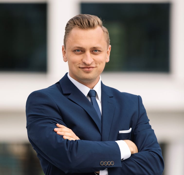 a man in a suit and tie standing in front of a building