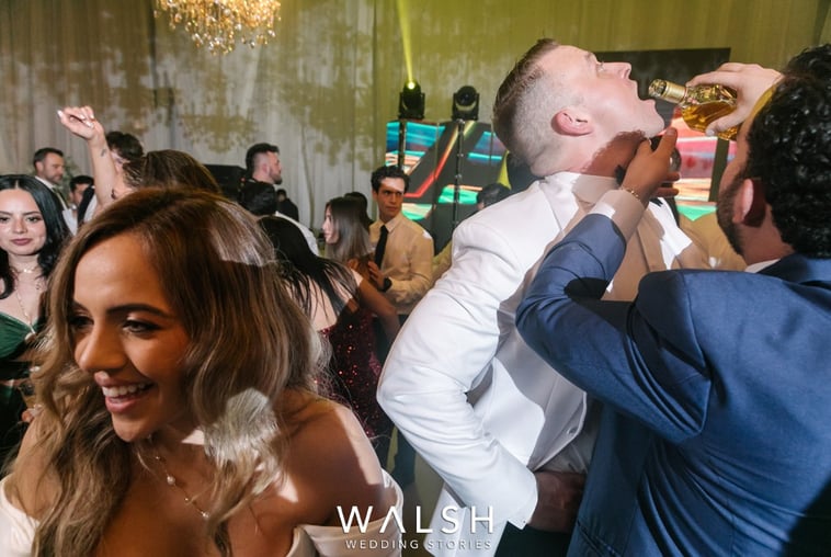 Antigua Guatemala wedding photographer-groom drinking at party