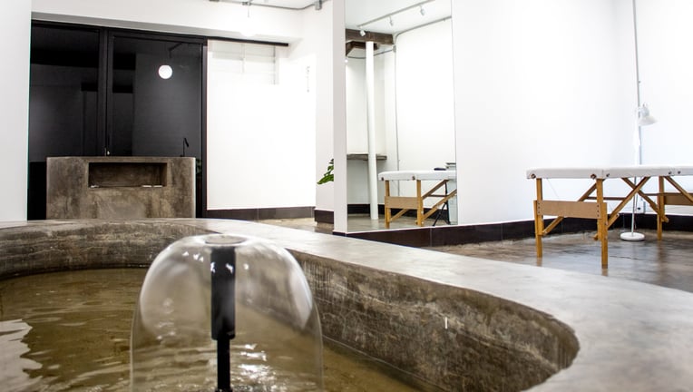 a bathtub with a large tub in the middle of a room